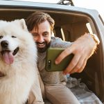 man-with-dog-samoyed-outdoors-at-the-beach-3737U6E.jpg